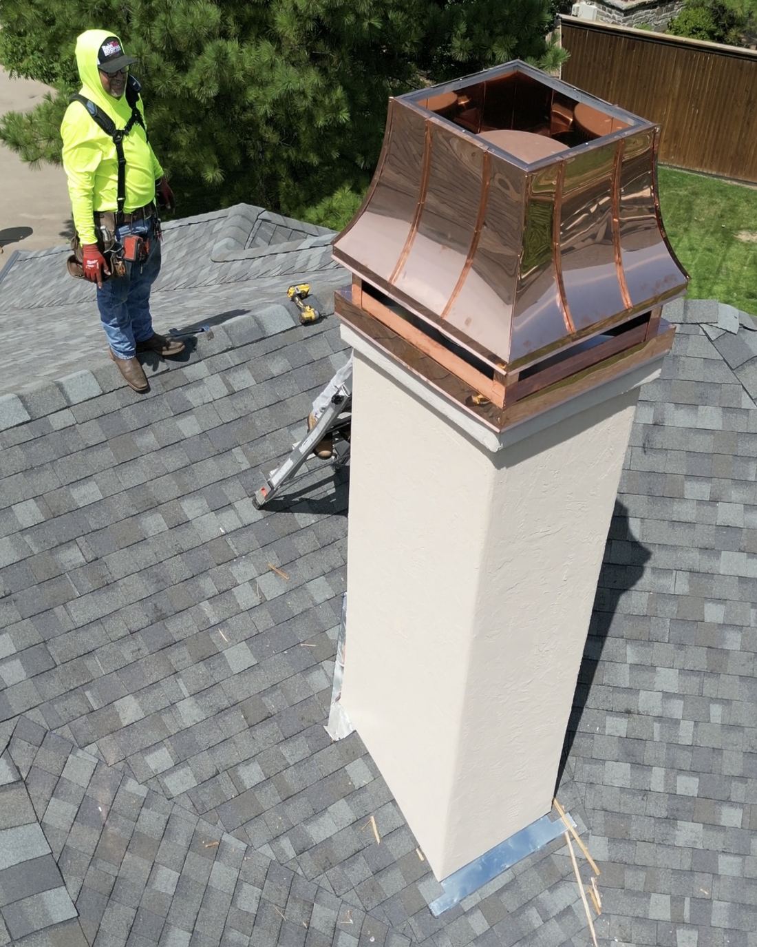 Copper chimney cap fabricated by RainTech Roofing being installed