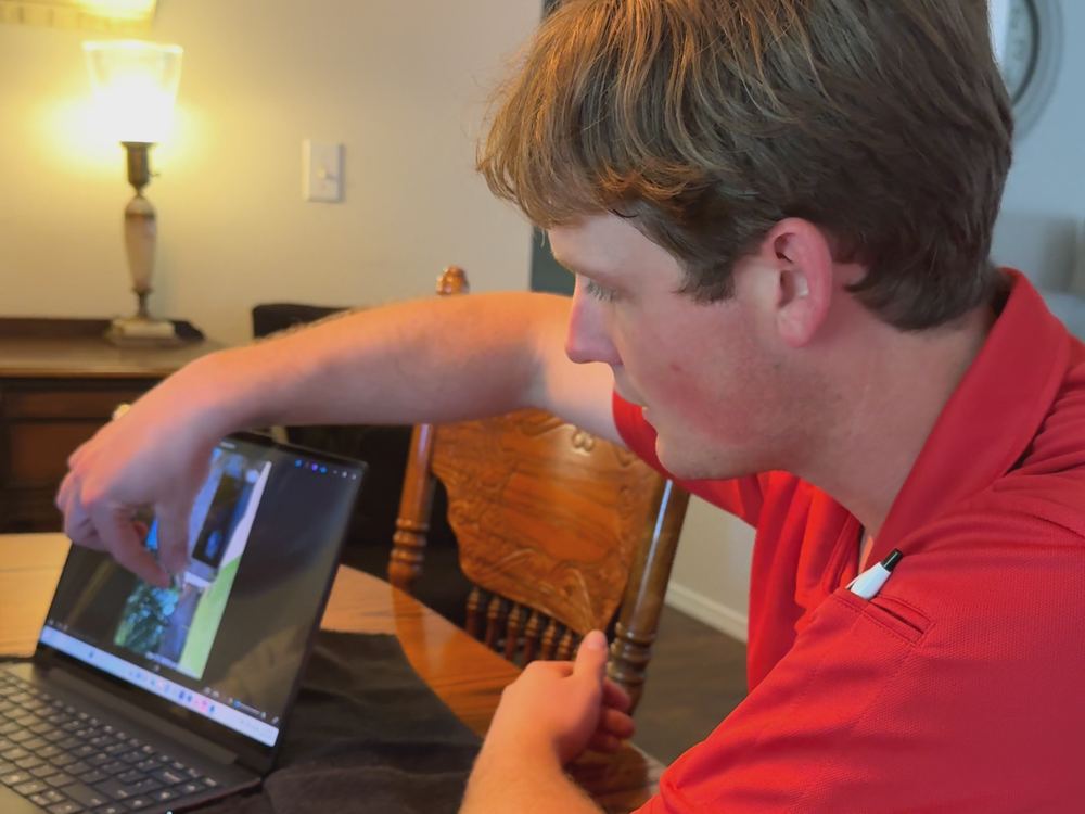 RainTech Roofing inspector reviewing roof photos with a homeowner